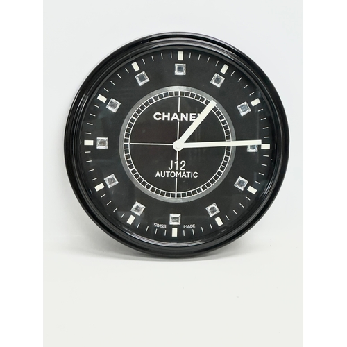 1007 - A Chanel advertising wall clock. 34cm