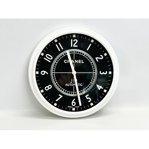 1009 - A Chanel adverting wall clock. 34cm