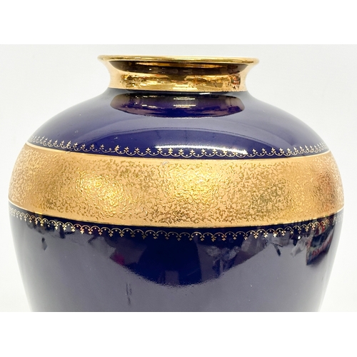 527 - KPM Royal Porzellan. A large cobalt blue and gilt porcelain baluster vase. 24x33cm