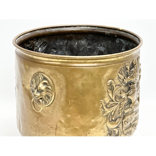 509 - A 19th Century Victorian embossed brass log bin/coal bucket with lion mask ring handles. 35x30x28cm