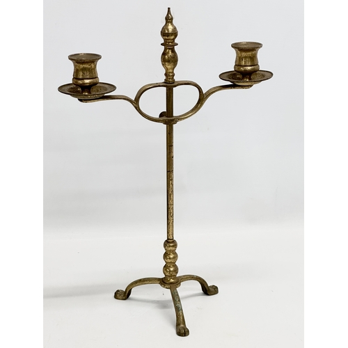 528 - A pair of Victorian brass candlesticks and a brass rise and fall candelabra.