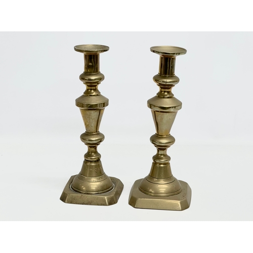 528 - A pair of Victorian brass candlesticks and a brass rise and fall candelabra.