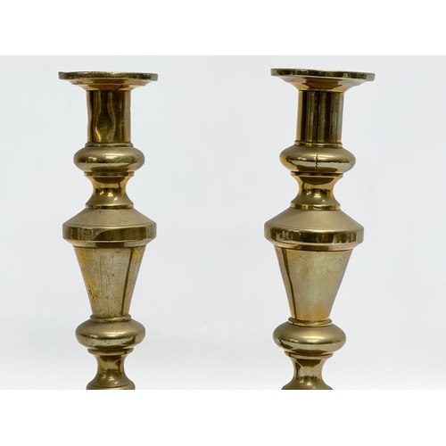 528 - A pair of Victorian brass candlesticks and a brass rise and fall candelabra.