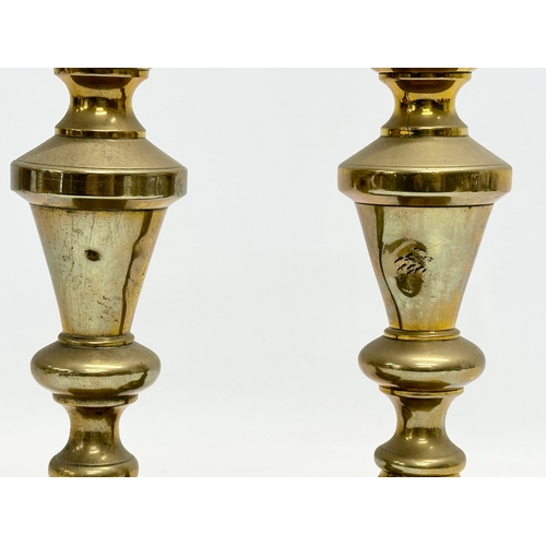 528 - A pair of Victorian brass candlesticks and a brass rise and fall candelabra.