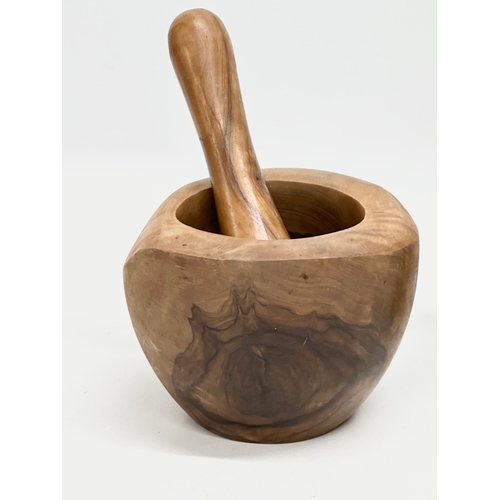 546 - A yew wood and granite mortar & pestles. 15x13cm. 12x9cm