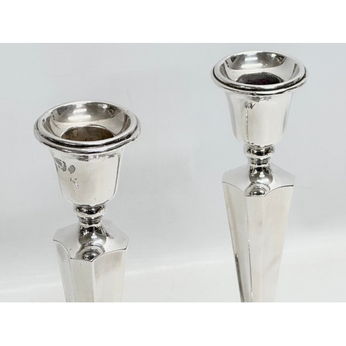 589 - A pair of silver candlesticks. Chester. Filled. 26.5cm