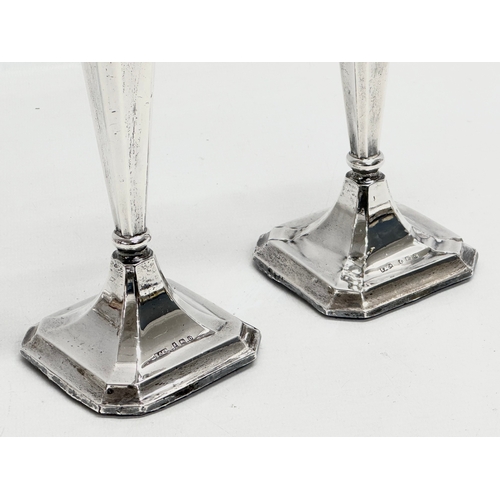 595 - A pair of Early 20th Century silver candlesticks. Birmingham, 1938. Filled. Sydney & Co. 20.5cm