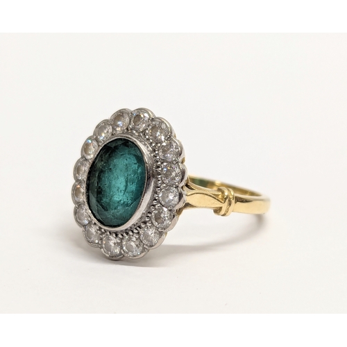 618 - An 18ct gold statement ring with an oval cut emerald and surrounding diamonds. Total weight 4g. Ring... 