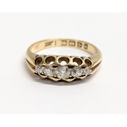 620 - An 18ct gold ring with 5 diamonds. Total weight 4g. UK size L