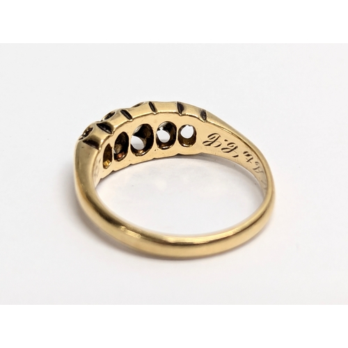 620 - An 18ct gold ring with 5 diamonds. Total weight 4g. UK size L