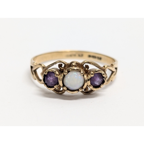 630 - A 9ct gold ring with opal and amethyst stones. Total weight 2g. UK size R