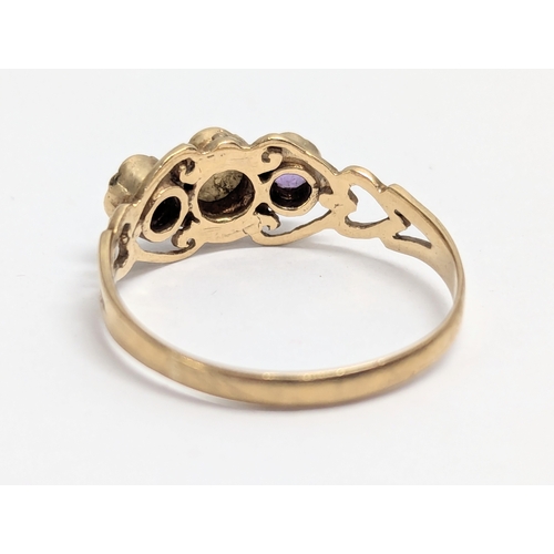 630 - A 9ct gold ring with opal and amethyst stones. Total weight 2g. UK size R