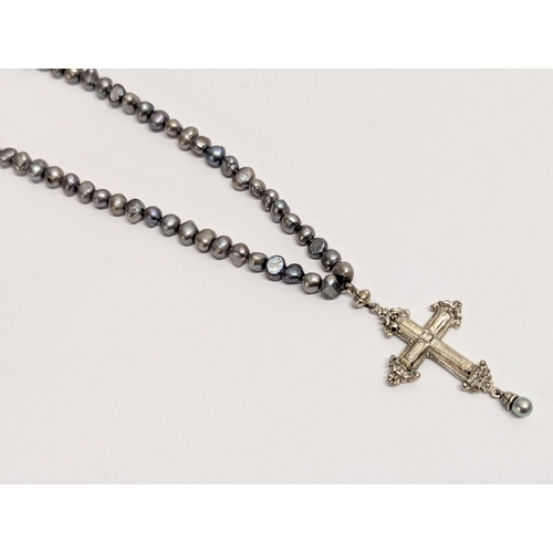 638 - A pearl and silver cross necklace.