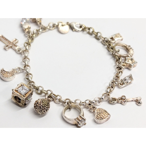 641 - A silver charm bracelet. Total weight 27g