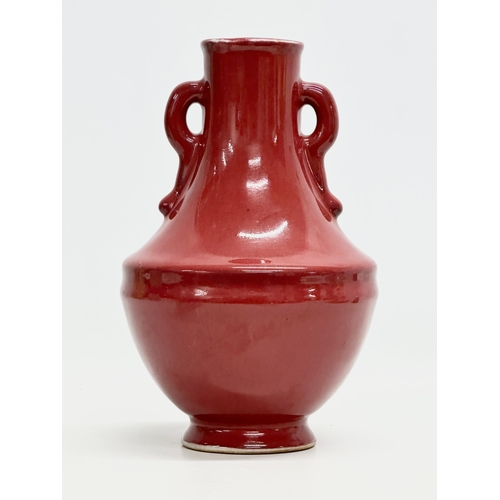 371 - A Chinese Sang De Boeuf glazed vase. 15x25cm