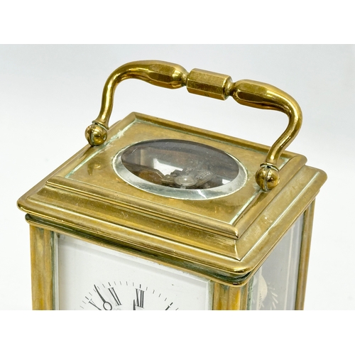 386 - Howell James & Co. A Late 19th Century brass carriage clock with 5 bevelled glass panels and key. 9x... 