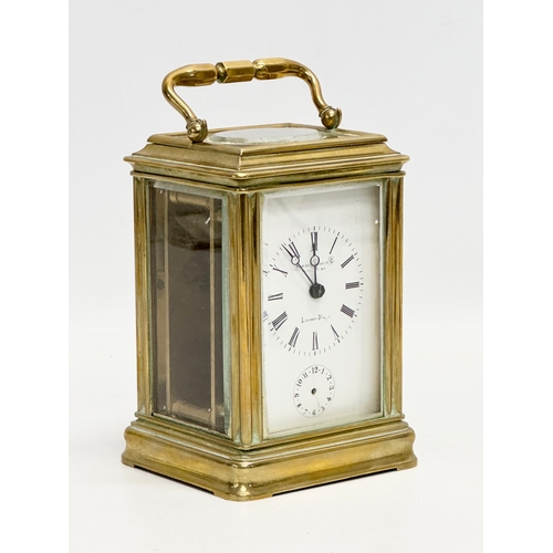 386 - Howell James & Co. A Late 19th Century brass carriage clock with 5 bevelled glass panels and key. 9x... 