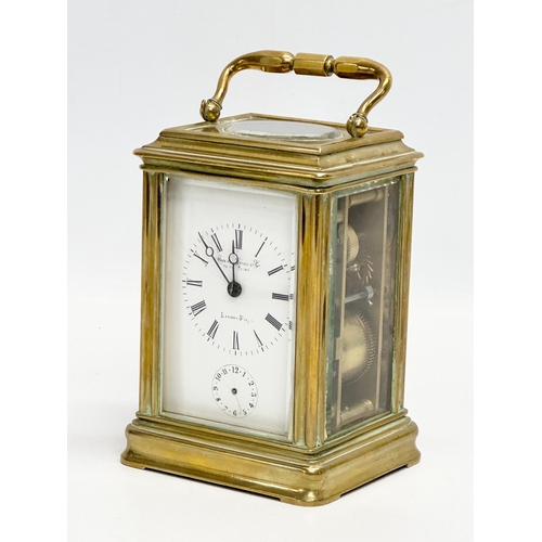 386 - Howell James & Co. A Late 19th Century brass carriage clock with 5 bevelled glass panels and key. 9x... 