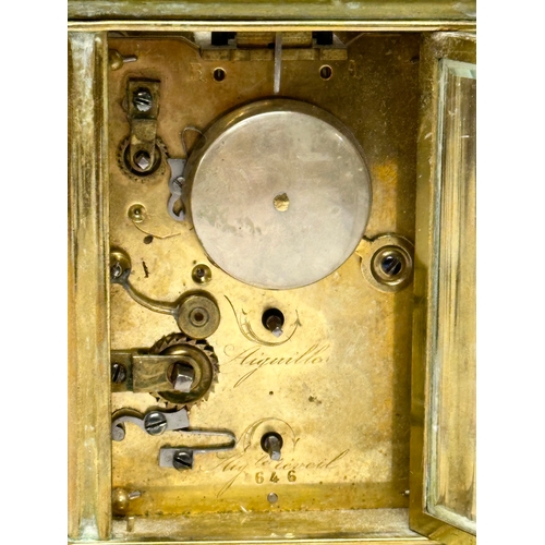 386 - Howell James & Co. A Late 19th Century brass carriage clock with 5 bevelled glass panels and key. 9x... 