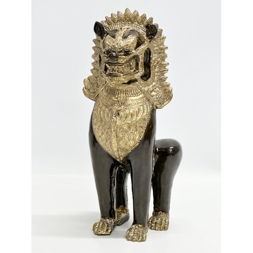 377 - Three solid gilt brass Chinese statues. A large Khmer Lion 26cm. Elephants 19cm, 18cm.