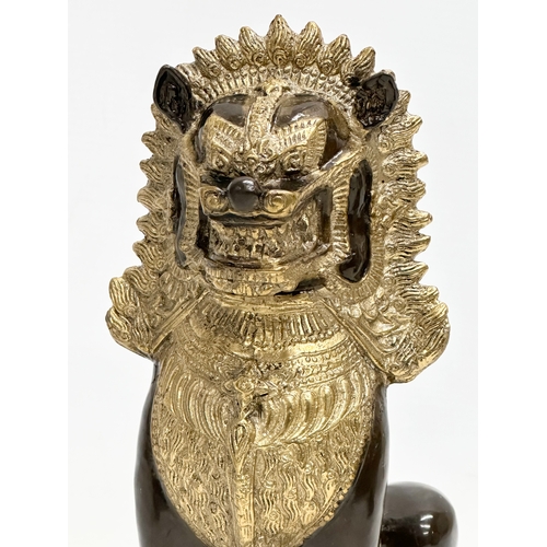 377 - Three solid gilt brass Chinese statues. A large Khmer Lion 26cm. Elephants 19cm, 18cm.