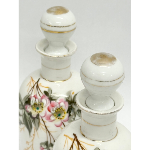 454 - A pair of Late 19th/Early 20th Century painted porcelain perfume bottles. 14cm