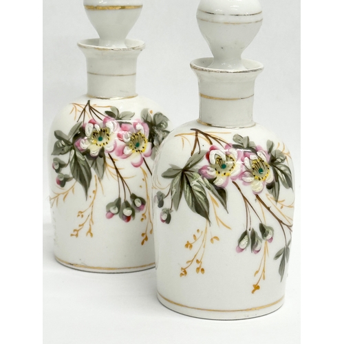 454 - A pair of Late 19th/Early 20th Century painted porcelain perfume bottles. 14cm