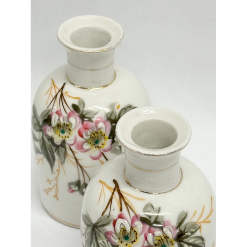 454 - A pair of Late 19th/Early 20th Century painted porcelain perfume bottles. 14cm