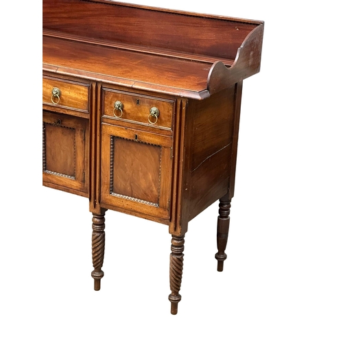 401 - An Early 19th Century, George IV mahogany gallery back sideboard. On turned wrythen legs, 3 drawers ... 