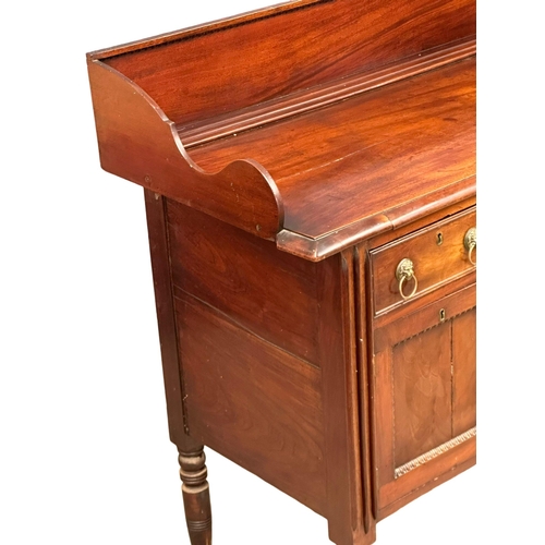 401 - An Early 19th Century, George IV mahogany gallery back sideboard. On turned wrythen legs, 3 drawers ... 