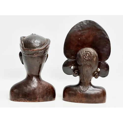 891 - A pair of Early 20th Century Balinese carved busts. Janger Dancer and other. 27cm. 22cm.