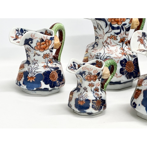 894 - A collection of 19th Century Ironstone China Imari jugs with serpent handles. 24x24.5cm. 20x21cm. 17... 