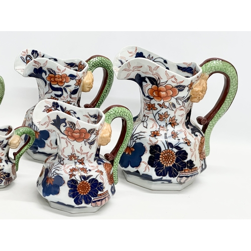 894 - A collection of 19th Century Ironstone China Imari jugs with serpent handles. 24x24.5cm. 20x21cm. 17... 