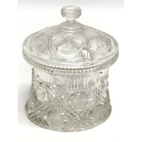 898 - A 19th Century American moulded glass jam pot with cover. 11x14cm