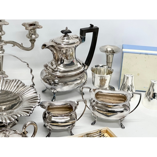 877 - A quantity of silver plate. A 3 piece Walker & Hall tea service, a Walker & Hall naval jug, Victoria... 