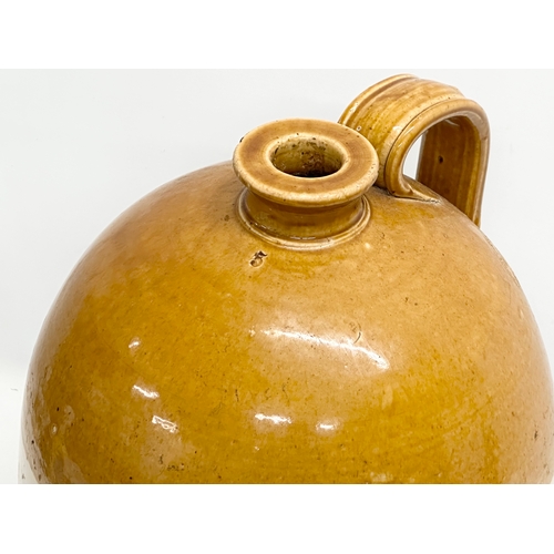 907 - A large Early 20th Century Possil Pottery flagon. 50cm