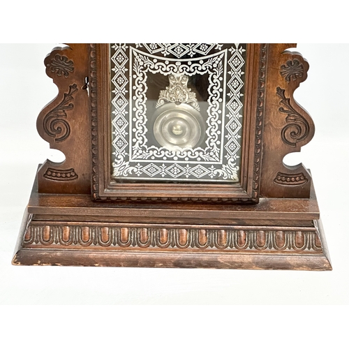 839 - A Late 19th Century gingerbread clock. With key and pendulum. 57cm