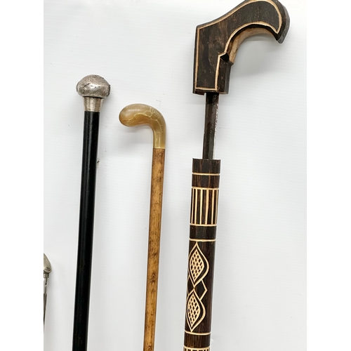 423 - 19th and 20th Century walking sticks. 2 silver mounted. A sword stick and a horse measuring stick.