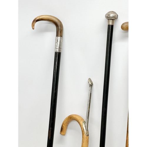 423 - 19th and 20th Century walking sticks. 2 silver mounted. A sword stick and a horse measuring stick.