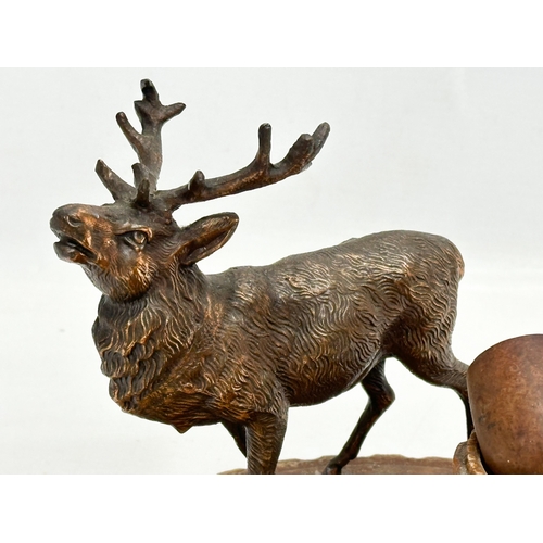 459 - An Early/Mid 20th Century smokers pipe stand with copper stag. 20x17cm