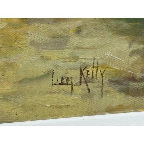 484 - Liam Kelly. A large oil on canvas. Working in the Farmyard. 61x51cm. Frame 80x69cm