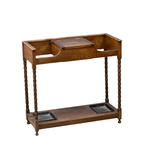 945 - An Early 20th Century oak umbrella stick stand. Circa 1920. 77x32.5x73.5cm (9)