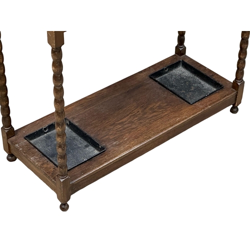 945 - An Early 20th Century oak umbrella stick stand. Circa 1920. 77x32.5x73.5cm (9)