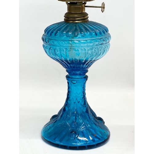 718 - 3 multicoloured glass oil lamps. 35cm. 32cm. 28cm