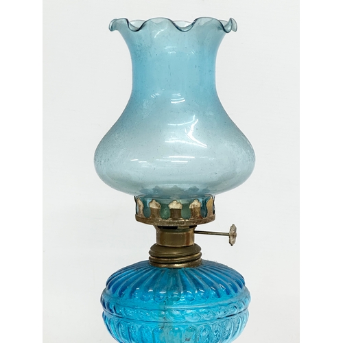 718 - 3 multicoloured glass oil lamps. 35cm. 32cm. 28cm