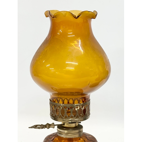 718 - 3 multicoloured glass oil lamps. 35cm. 32cm. 28cm