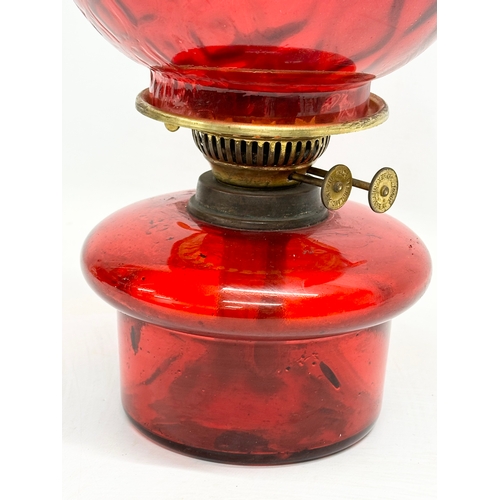 719 - An Early 20th Century ruby glass oil lamp bowl and shade. 41cm