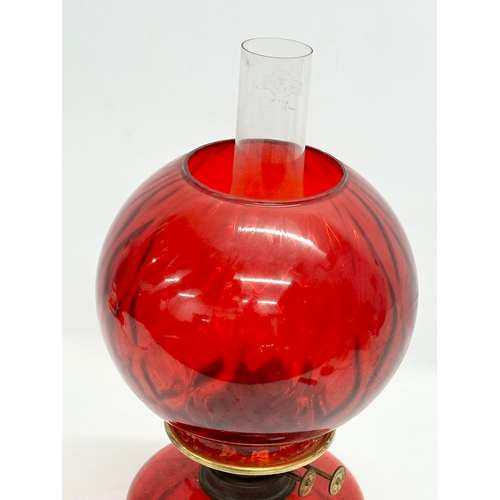 719 - An Early 20th Century ruby glass oil lamp bowl and shade. 41cm