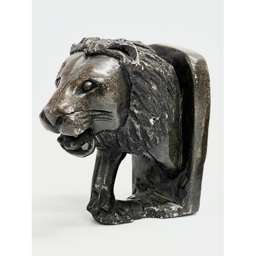 726 - A pair of carved soapstone lion bookends. Head 17x11x18cm