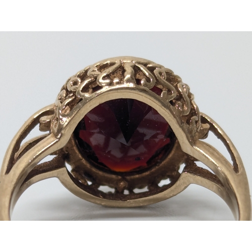 677 - 9ct gold garnet ring. UK size P. 3.8 grams